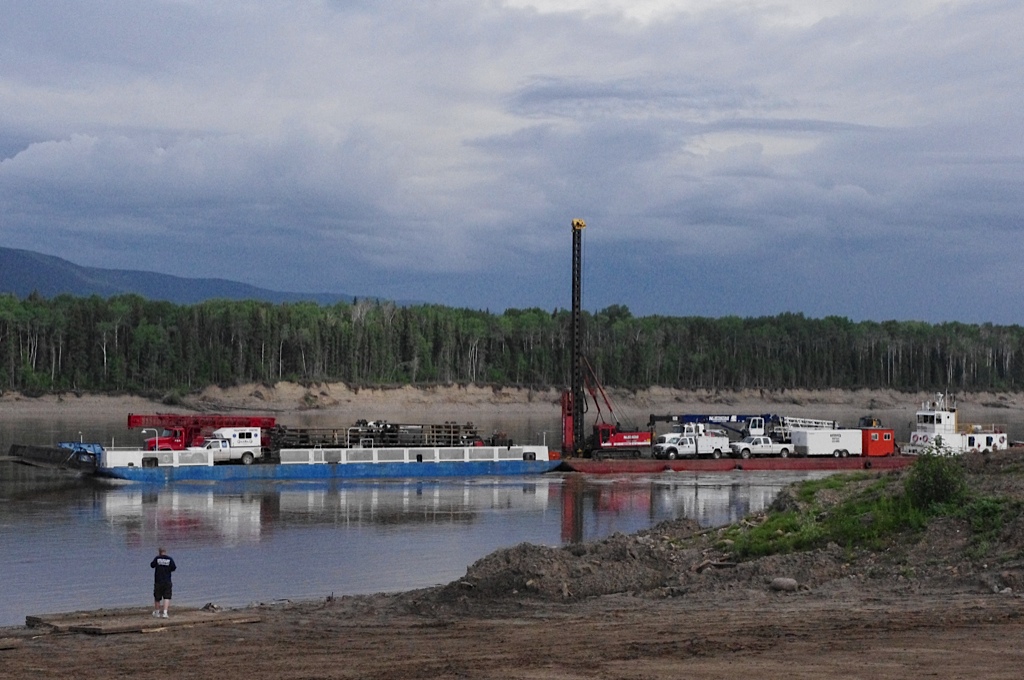 Drilling trucks on lake