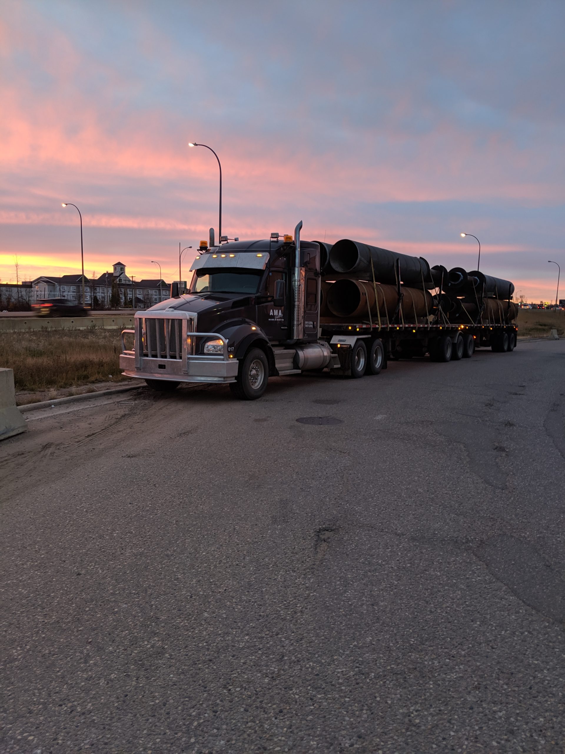 Truck with pipes at sunset