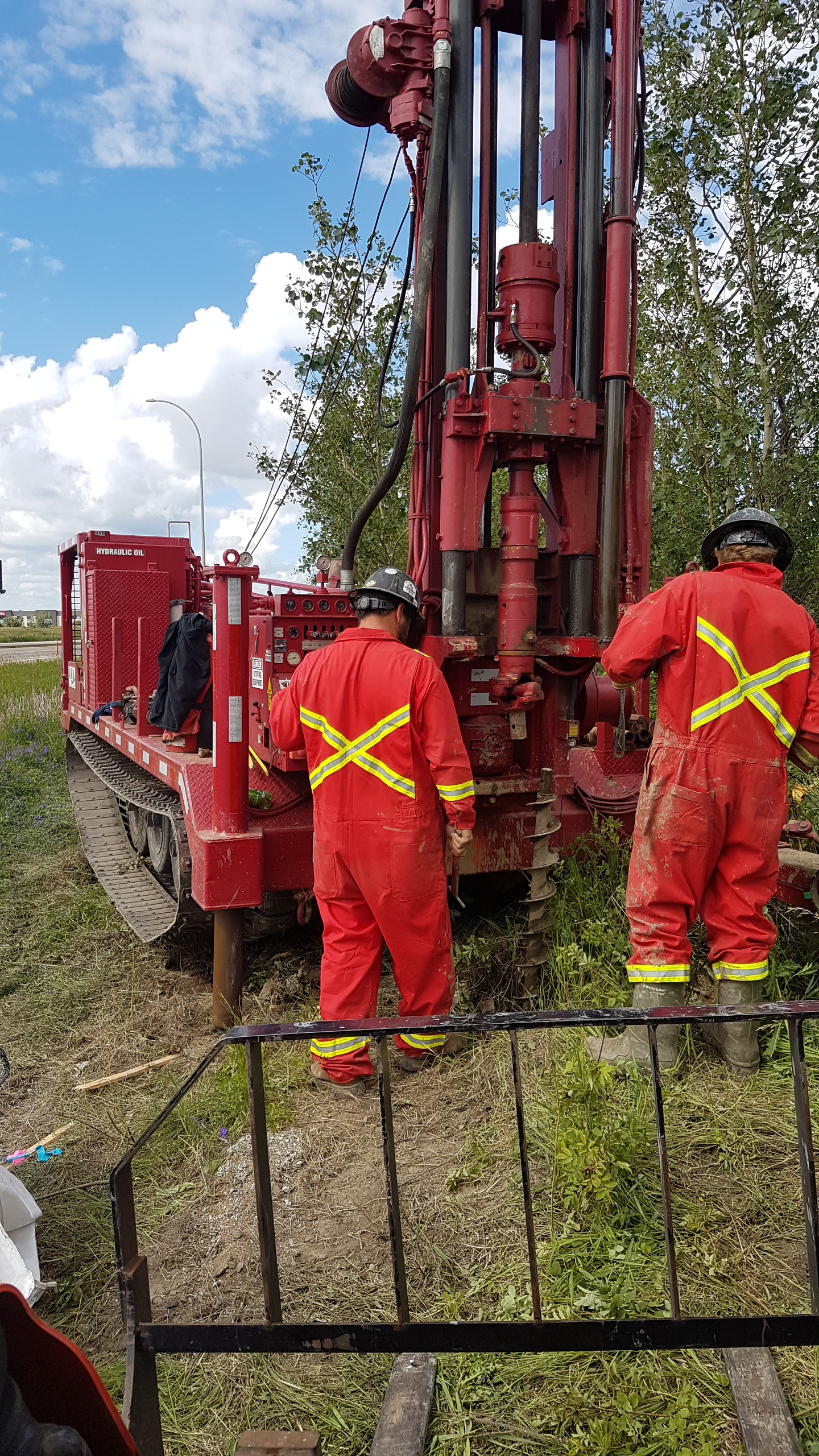 Two workers with drill