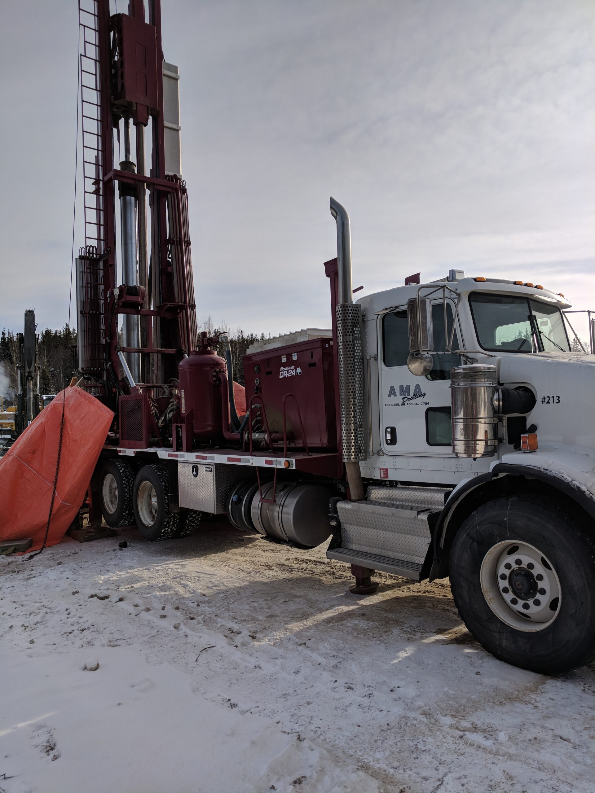 White drilling truck in snow